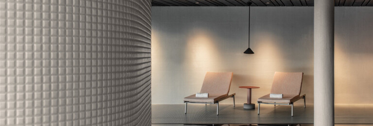 Swimming pool area - Appiani mosaic gloss tiles covered columns. Acoustic ceiling in spruce wood. Dropped ceiling black wood stained planks. Rail sunbeds by Pedrali. Roll side table by Patricia Urquiola for Kettal. Nod suspended light by XAL.